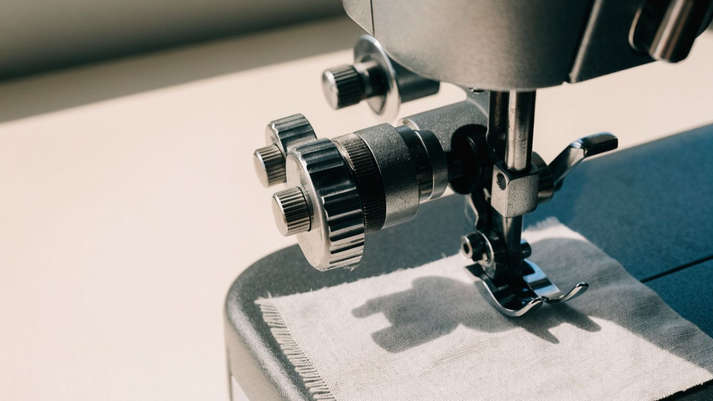 Close-up of sewing machine controls used to adjust stitch settings during beginner practice Basic Sewing Machine Settings and Controls